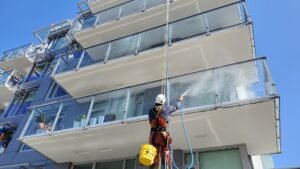 cleaning window of high rise building