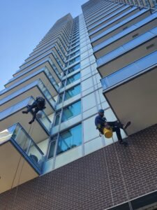 high-rise team cleaning windows